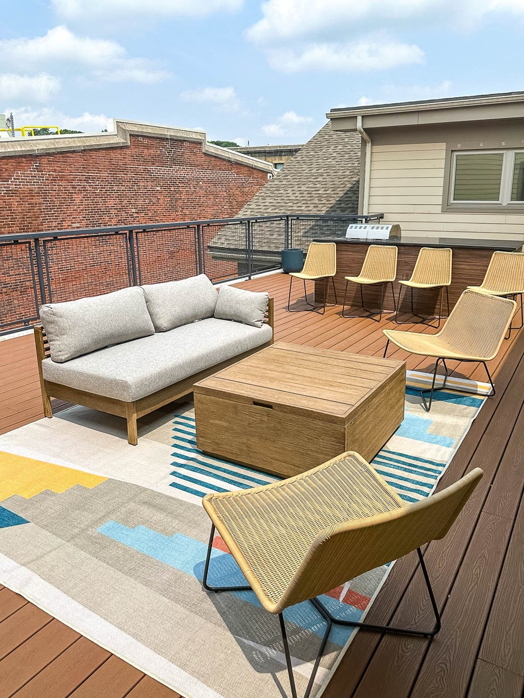 a furnished patio with a couch and chairs and tables